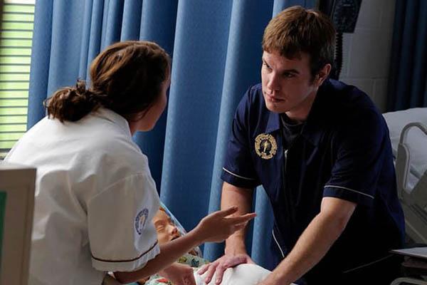 Nursing students practicing on a training dummy