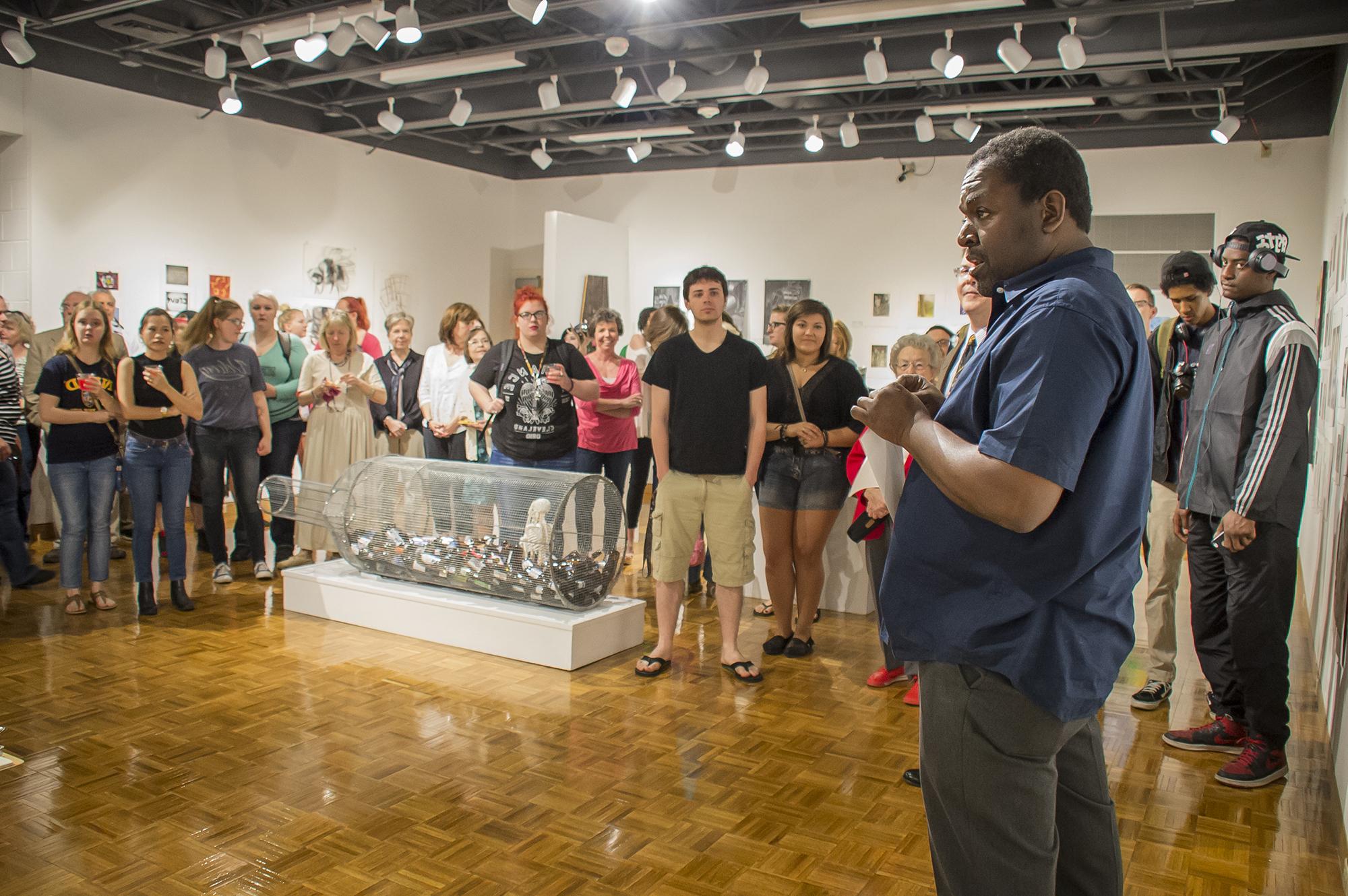 A professor talking about art pieces inside the Shircliff Humanities Building