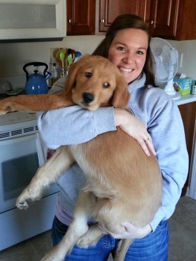 Lindsay Seals holding her golden retriever