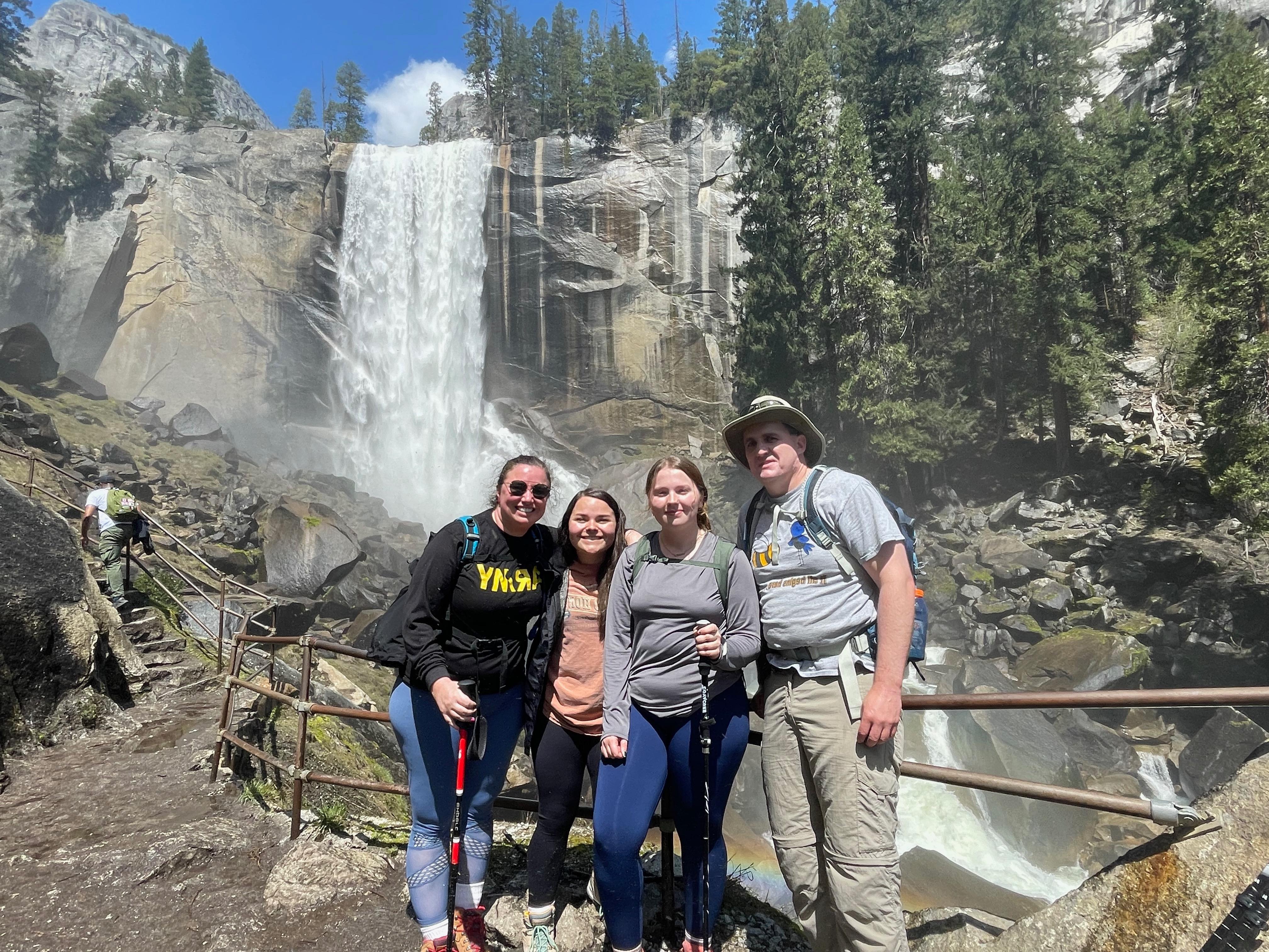 The Biology Club posing for a photo in front of a waterfall