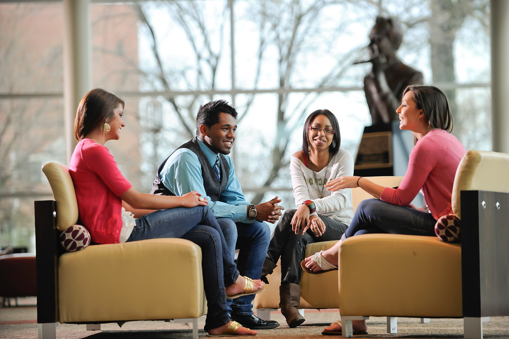 4 students having a discussion in the student union